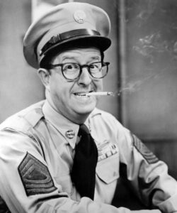 Phil_silvers_as_bilko – Movie Review Celebrate the life and legacy of Phil Silvers (1912-1985), a beloved comedian and actor known for his roles in classic films and television. Discover his career milestones, family life, and lasting influence on comedy.